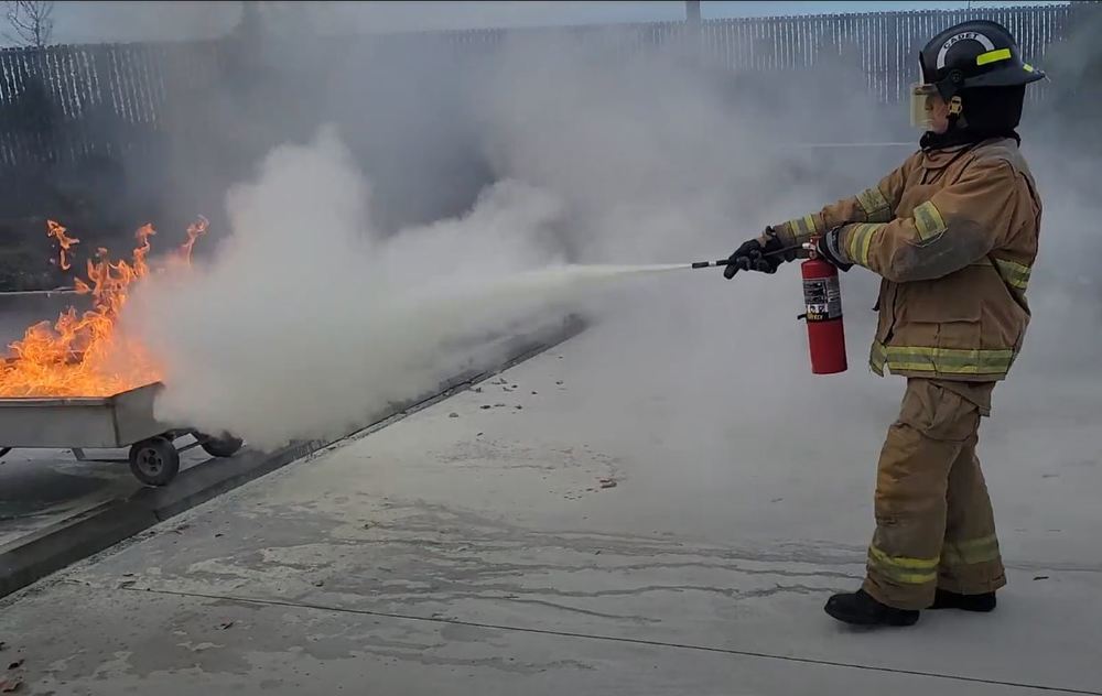 Student extinguishing a fire