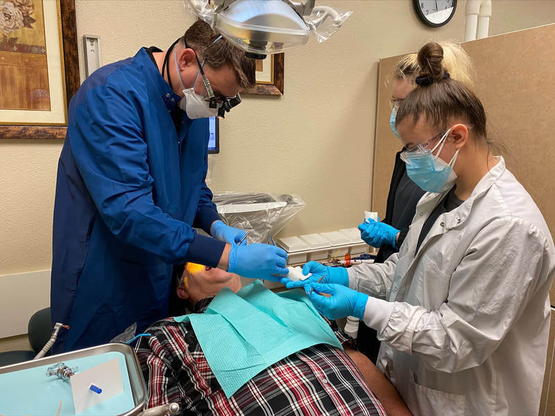 Dentist and student assistant working on a patient