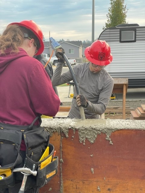 students pumping concrete