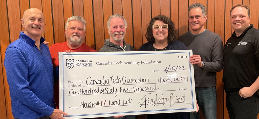 Cascadia Tech Board Members holding large oversized check